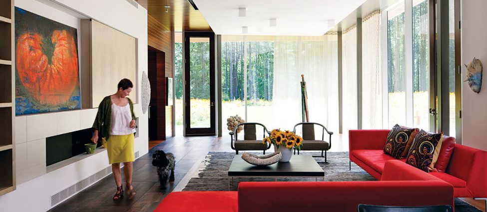 Homeowner Deb Hawkins in her living room of her contemporary home in Lincoln, Massachusetts.