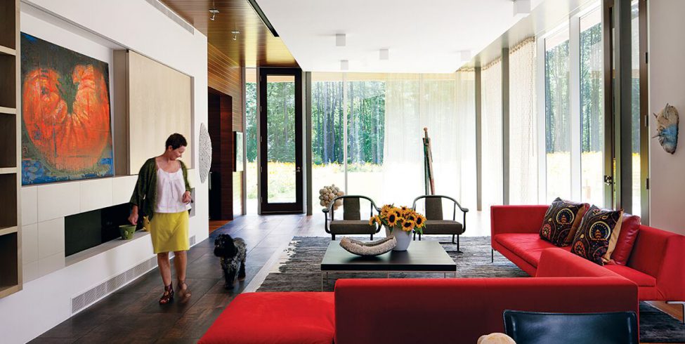 Homeowner Deb Hawkins in her living room of her contemporary home in Lincoln, Massachusetts.